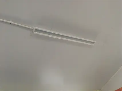 dual tube fluorescent light fixture mounted on an indoor ceiling, typical of dual t5/t8 combination fixtures for general lighting applications
