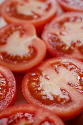 freshly sliced better boy beefsteak tomatoes showing juicy red flesh and seed cavities