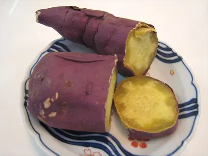 japanese sweet potato (purple-skinned variety) whole and sliced on decorative plate - japanese sweet potato purple