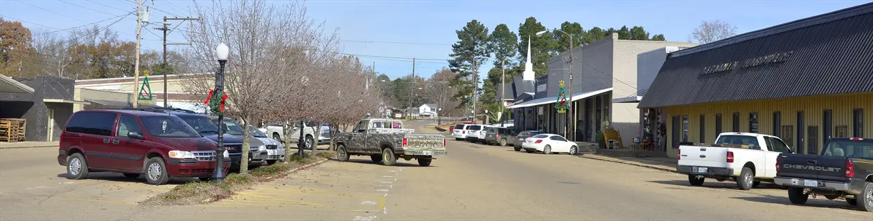 small-town main street scene in vardaman with parked vehicles and historic storefronts